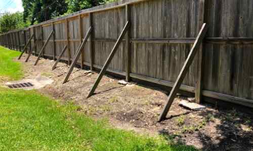 broken wood fence needs repaired